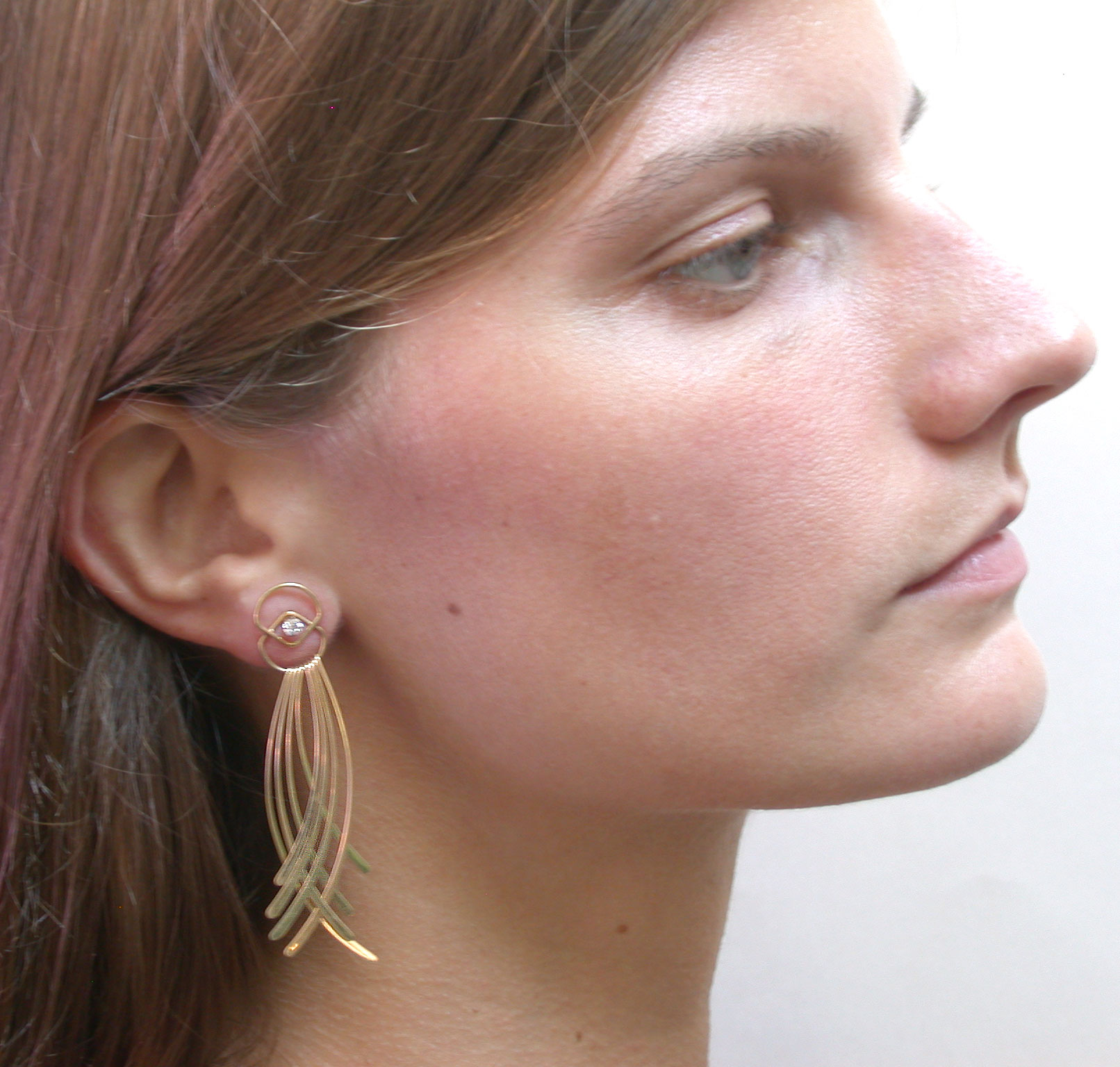 Model Wearing Gold Fringe Crossing Earring Jacket